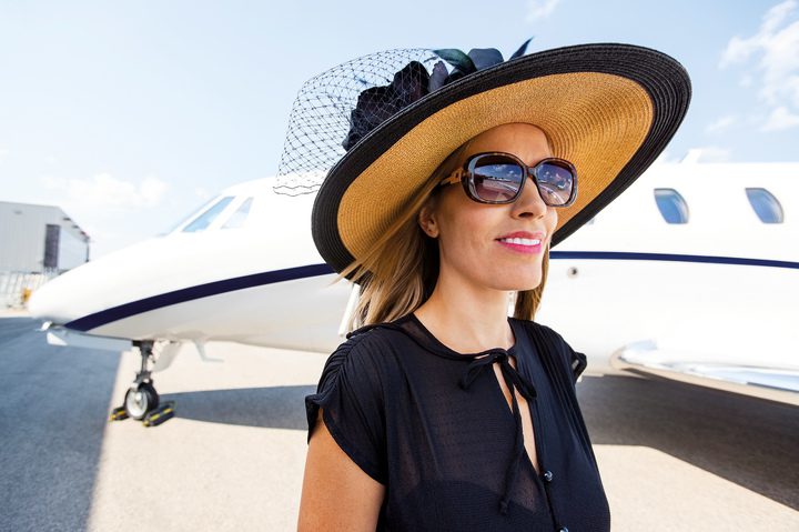 A woman comparing herself to an image on a phone