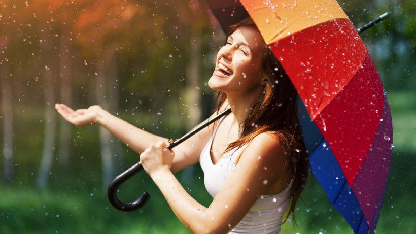 Woman looking in the mirror with positive affirmation sticky notes